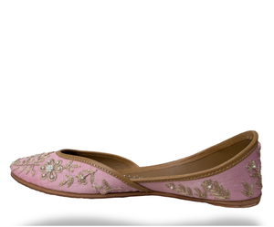 Pink embroidered shoe on a white background